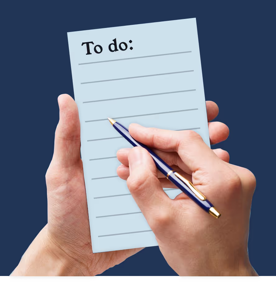 A couple of hands holding a todo list about to right in the notepad